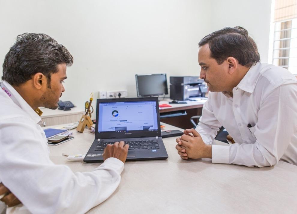 Indian pharmaceutical professional using digital technology to plan AI adoption and business transformation